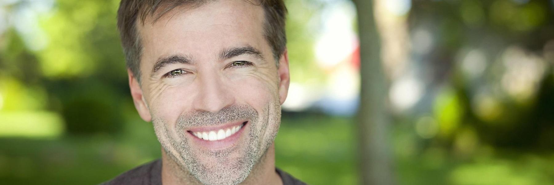 Man smiling after getting dental implants from CS Family Dentistry
