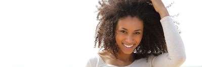 A lady smiling after getting a dental implant at CS Family Dentistry, Bastrop,TX
