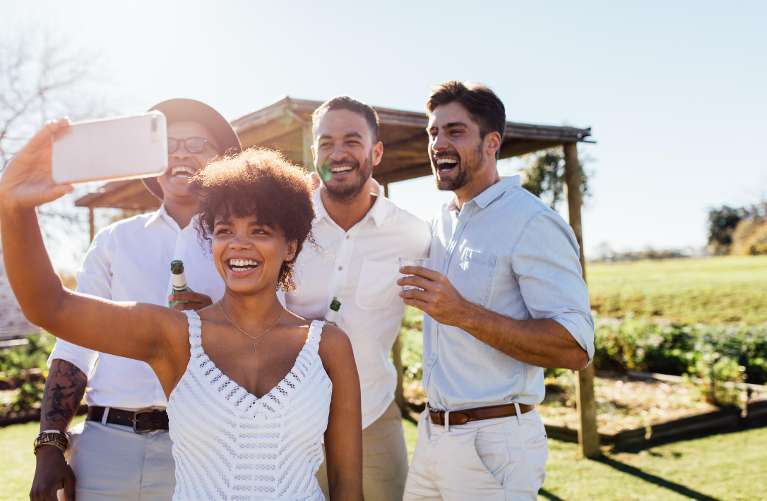 Group of friends taking a selfie with bright smiles after getting invisible braces in Bastrop.