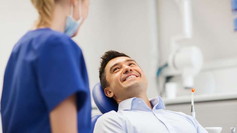 Picture of a dentist and a patient undergoing teeth whitening in Bastrop, TX 