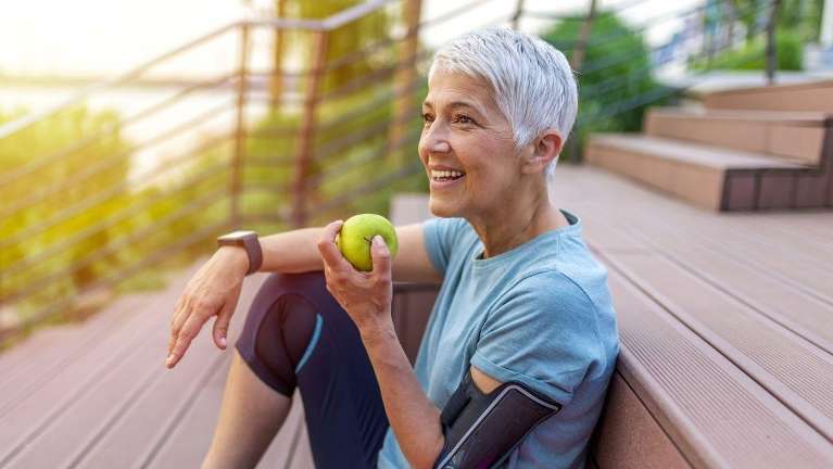 A lady eating an apple in Bastrop, TX