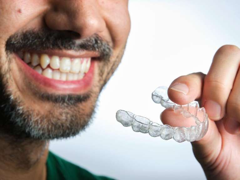 A patient tying out Invisalign Braces in Bastrop, TX