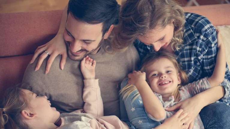 A picture of a happy family smiling in Bastrop, TX