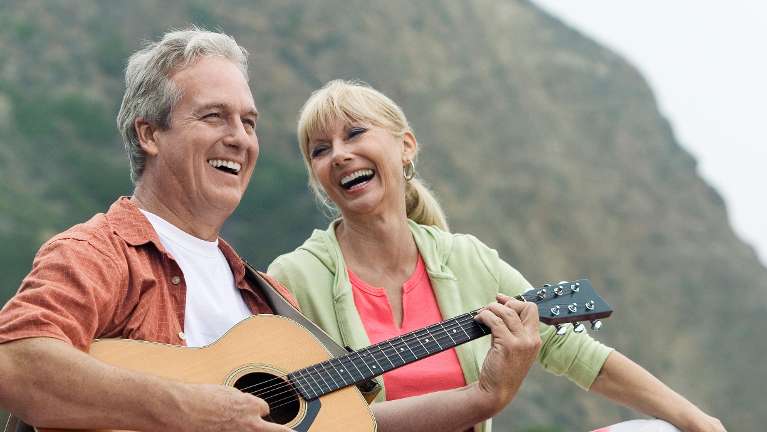 A couple enjoying playing guitar after visiting CS Family Dentistry in Bastrop, TX
