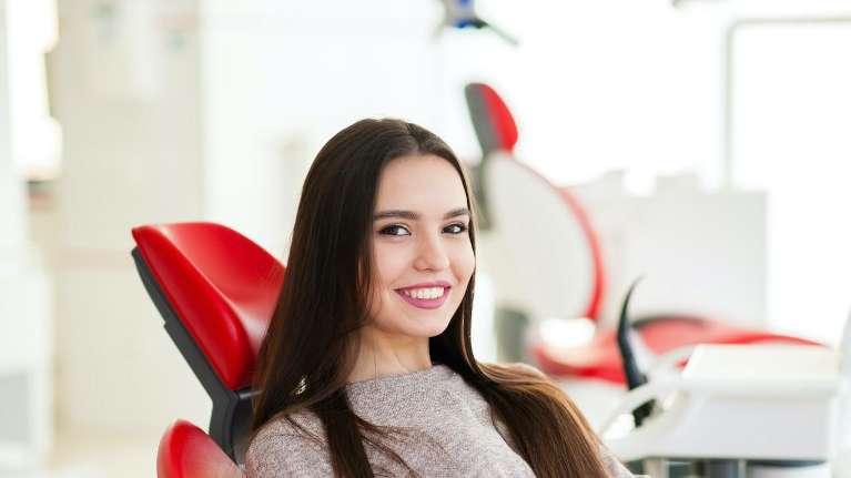 A young lady with Dental Implants in Bastrop, TX