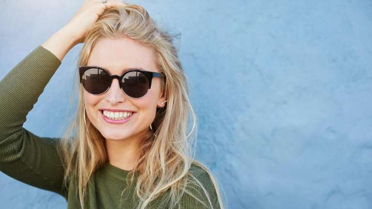 A lady smiling after getting a dental implant at CS Family Dentistry, Bastrop, TX