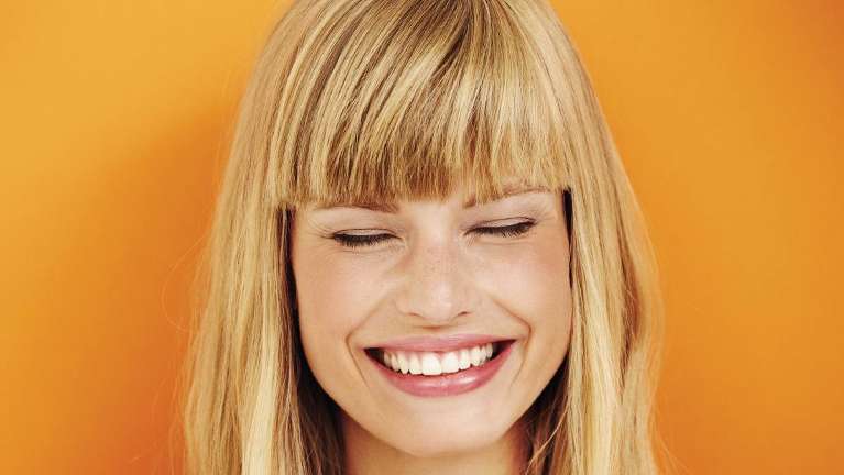A patient smiling after getting porcelain veneers from CS Family Dentistry, Bastrop, TX
