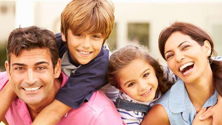 A picture of a smiling family in Bastrop, TX.