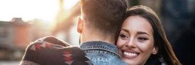 Lady hugging her fiancé while smiling after teeth whitening at in Bastrop, TX