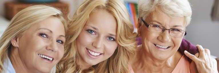 Family pose for a photo after Cosmetic Dentistry session in Bastrop, TX