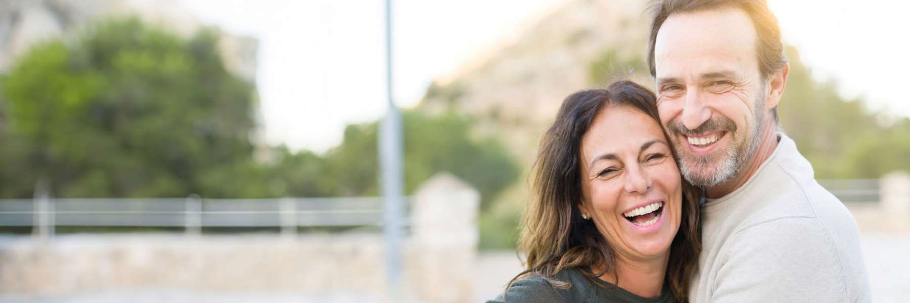 Smiling couple enjoying healthy smiles after Bastrop endodontic care.